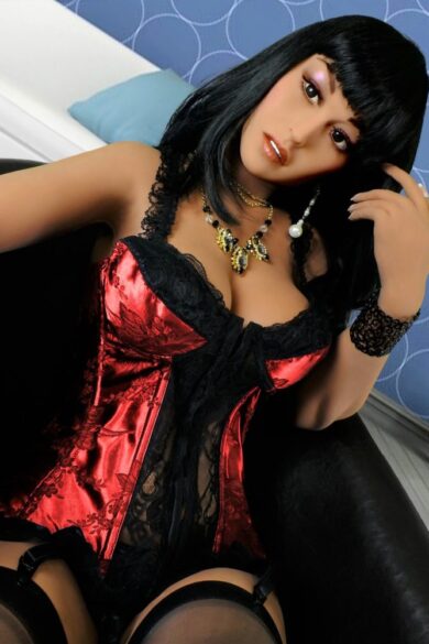 Adrienne 165cm French Woman sex doll in red and black lace outfit on dark couch with blue patterned wall backdrop