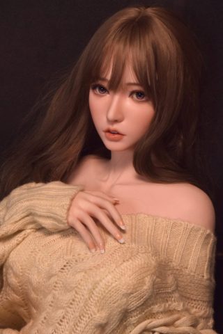 Fukada Ryoko 165cm doll with long brown hair, wearing an oversized beige sweater, posing softly against a dark background.