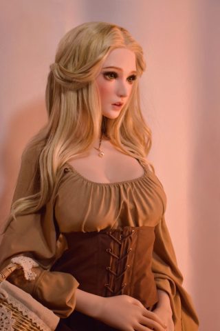 Mai – 165cm Elsa Babe silicone sex doll wearing a brown corset and a beige blouse, with long blonde hair.