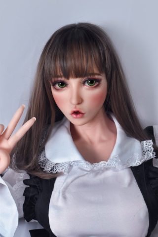 Satone – 150cm Elsa Babe Silicone Sex Doll with long brown hair, green eyes, and a white blouse with black accents, posing peace sign.