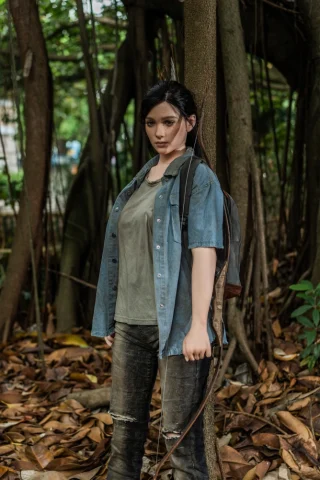 Ellie The Last of Us doll stands 6 feet tall, wearing a denim shirt over a green top, with a bow and arrows.