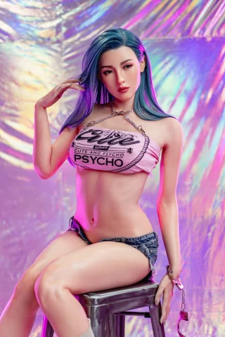Katana 170cm C Cup Zelex sex doll with fair skin wearing a cropped graphic top and denim shorts, posed on a stool against a colorful backdrop.