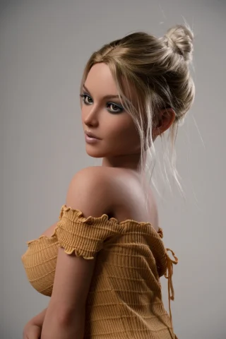 Scarlett 165 cm F Cup G53 Tan Zelex Sex Doll wearing a yellow off-shoulder top, with long blonde hair styled in a bun.