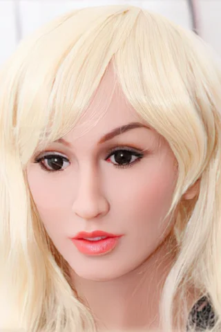 Doll head with long blonde hair and brown eyes, featuring a natural skin tone and subtle makeup.