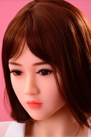 120cm doll with short brown hair and a neutral expression against a pink background.