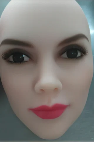RealLady doll head with realistic features, including dark eyes, long eyelashes, and pink lips.