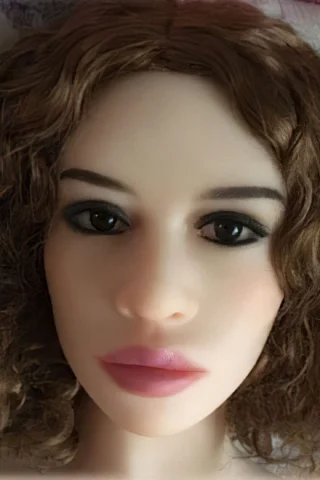 Doll 127 features a realistic face with curly brown hair, dark eyes, and full lips.