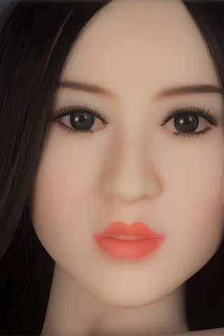 Doll 138 features long black hair, a smooth face with detailed eyes, and soft pink lips.