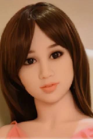 164cm doll with long brown hair, wearing a pink top, sitting against a light background.