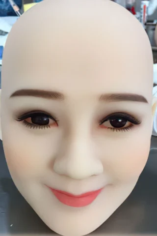 191 doll head with a smooth, bald surface, featuring detailed facial features, dark eyes, and a subtle smile.
