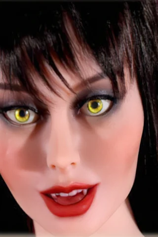Vampire doll with long black hair and striking yellow eyes, featuring bold makeup and a seductive expression.
