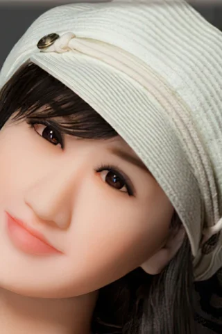 Doll 208 with a white hat, featuring long dark hair and a soft smile, resting against a patterned background.