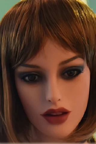 Doll with short brown hair, wearing dark eye makeup and deep red lipstick, against a soft green background.