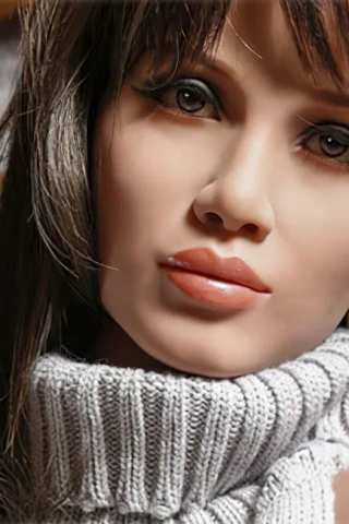220cm doll with long dark hair wearing a gray turtleneck sweater and large hoop earrings, gazing directly at the camera.