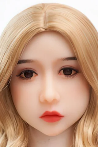 Doll 228 with long blonde hair and soft facial features, displaying detailed eyes and natural lip color.