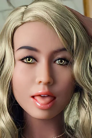 Doll with blonde hair and green eyes, playfully touching her hair in a bright setting.