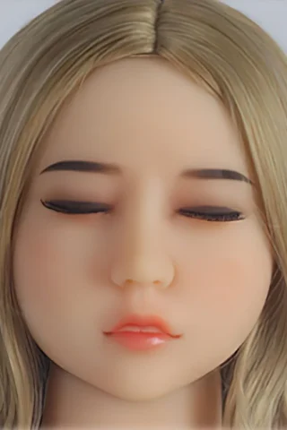 Doll with closed eyes and blonde hair, featuring a smooth complexion and soft pink lips.