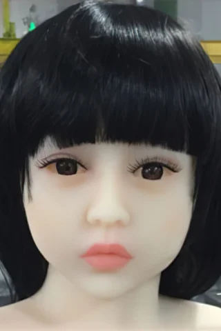 300cm doll with straight black hair and a smooth face, featuring large eyes and a neutral expression.
