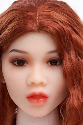 310 doll with wavy red hair and natural makeup, featuring brown eyes and a neutral expression.