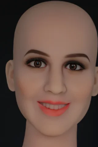 Bald doll with a smooth face, brown eyes, subtle makeup, and a slight smile against a dark background.