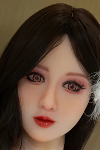 Doll with long dark hair and feather accessory, featuring large expressive eyes and a subtle makeup look.
