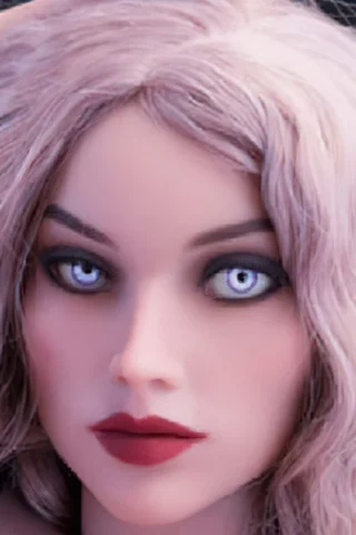 Doll with long wavy pink hair and striking blue eyes, wearing dark makeup and a black outfit.