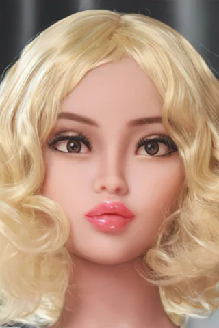 369 doll with curly blonde hair and soft facial features, set against a gray background.