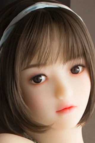 Doll, short hair with a blue headband, featuring soft facial features and brown eyes.