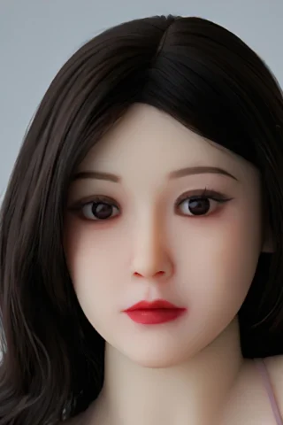 392 doll with long dark hair and natural makeup, featuring a neutral expression and soft facial details.