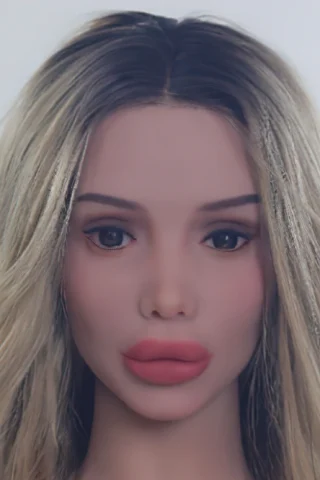 Doll head with long blonde hair, soft facial features, and full lips against a plain background.