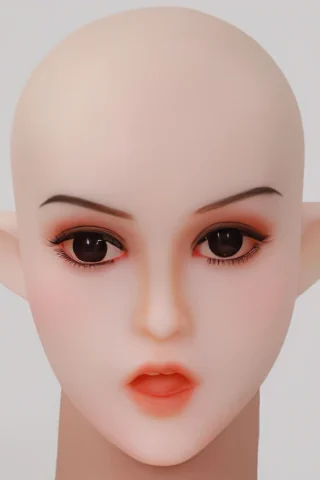 Elf doll head with pointed ears, featuring large dark eyes, soft pink cheeks, and a neutral expression.
