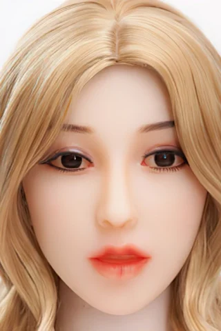 Doll head with long blonde hair, soft features, and brown eyes, set against a plain white background.