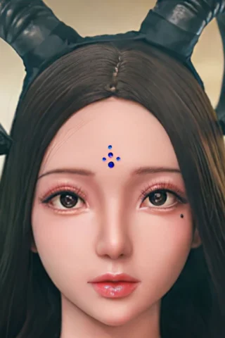Demoness doll with long dark hair, featuring prominent horns and a blue gem on her forehead.