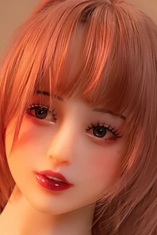 Doll, close-up of a female figure with light brown hair and subtle makeup, featuring a soft expression.