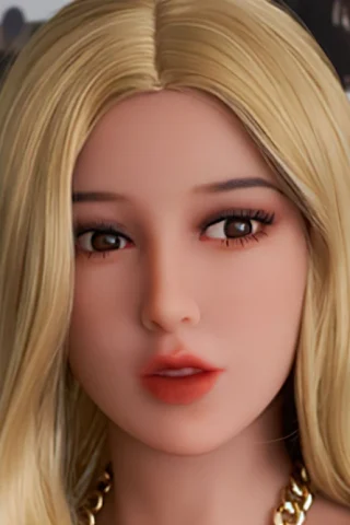 Doll, 158cm, with long blonde hair, wearing a gold chain, and set against a blurred background of photographs.