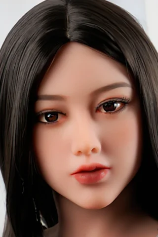 Doll, long dark hair, realistic facial features, wearing a casual outfit, soft lighting in a bright setting.
