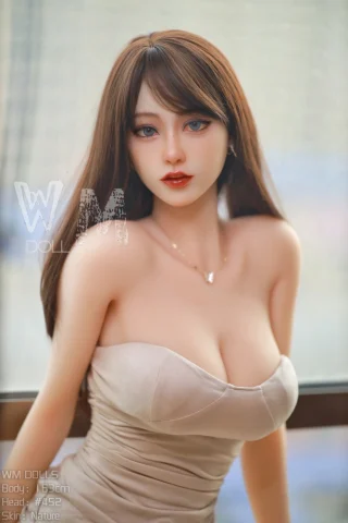 Ammi 163cm WM Doll poses in a strapless beige dress, showcasing long brown hair and a natural skin tone.