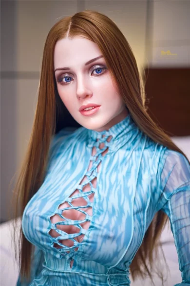 Figure of the S5 Cinderella 153cm Irontech sex doll with long hair and blue patterned top in a softly lit room, gazing into the camera.