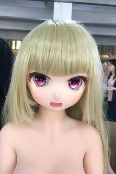 Life-sized doll head with blonde hair, large eyes, and open mouth expression