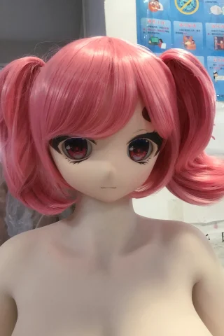 WM Doll head with pink hair and large eyes, featuring two pigtails and a neutral expression.