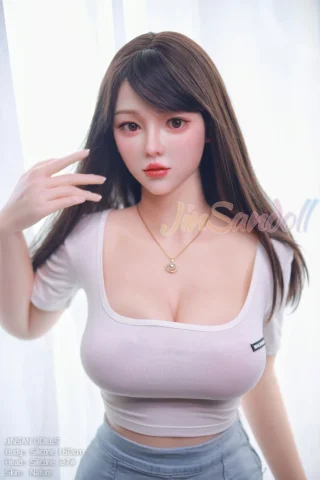 Jinsan 160cm F Cup #27 Silicone doll wearing a fitted white top, with long dark hair and a necklace, posed in a natural setting.