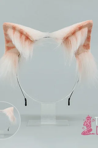 Cat Ears headband features soft pink and white fur with pointed ears, displayed on a clear stand.