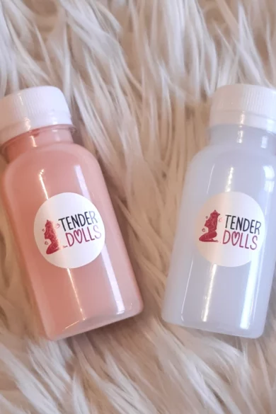 Two Silicone Sex Doll Glue Kit bottles in pink and light gray on a fluffy white surface evoke Love Doll aesthetics