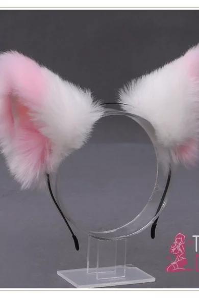 Furry Fluffy ears headband with pink and white fur on a clear stand against gray backdrop