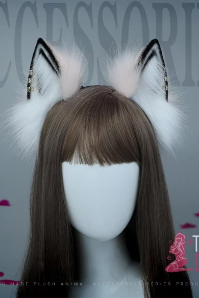 Love doll with posable antique fox ears and long brown hair in front of an ACCESSORIES backdrop