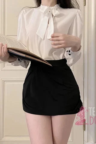 Secretary Skirt & Shirt features a white blouse with a bow tie and a black mini skirt, holding an open book.