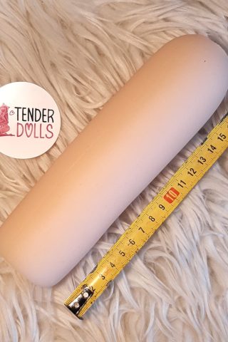 WM Doll Cyberskin Removable Vagina Insert, displayed on a fluffy white surface next to a measuring tape.