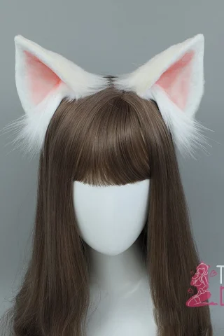 White Fox Ears headband features fluffy white ears with pink inner lining, set on a mannequin with long brown hair.