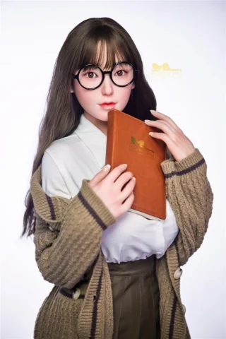 153cm Miku S14 Irontech Sex Doll wearing glasses, holding a brown notebook, dressed in a white blouse and knitted cardigan.