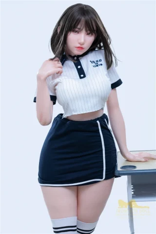 153cm Suki S20 Irontech Sex Doll wearing a cropped white and navy striped top and a matching skirt, posing with one hand on her hip.